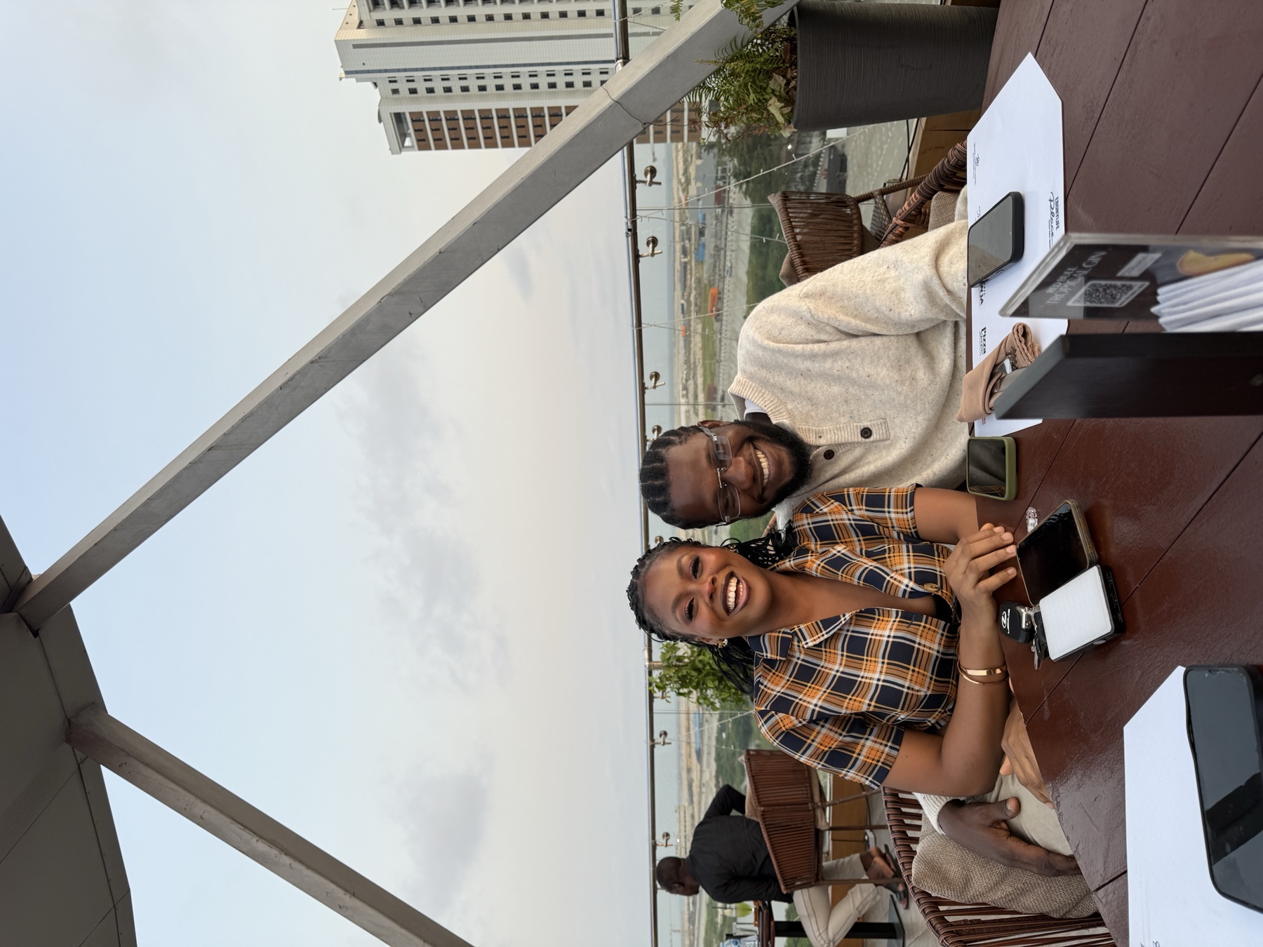 Doose and Deri seated together by the water